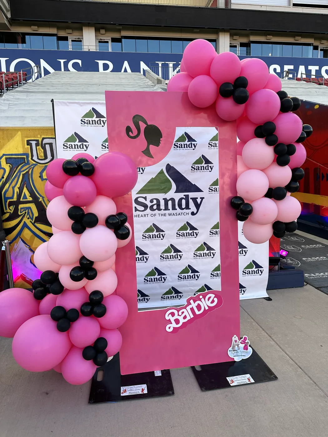 Life-size themed balloon photo box at a community event